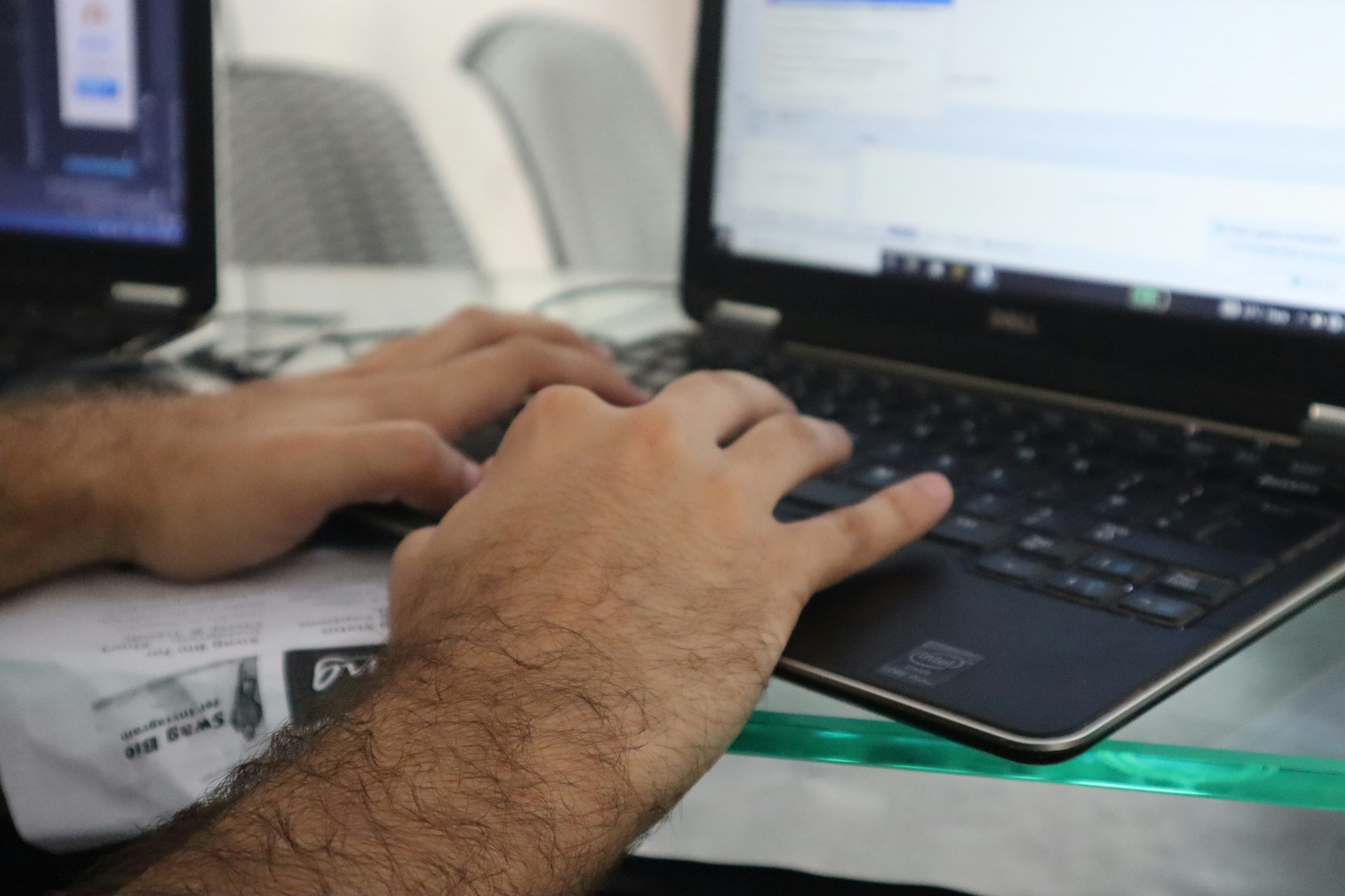 a man is typing on a laptop computer